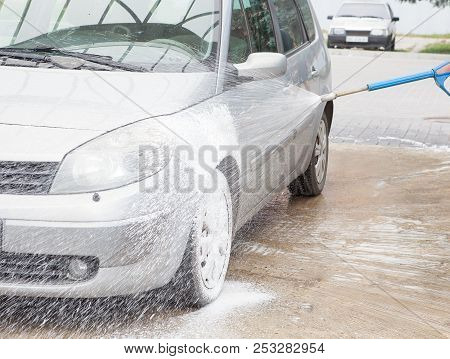Car Wash With Foam In Car Wash Station. Carwash. Washing Machine At The Station. Car Washing Concept