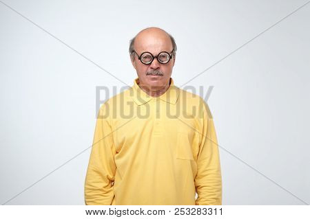 Mature Man In Funny Glasses Looking At Camera.