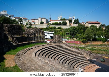 The Ancient Roman Theatre Of Fourviere And The Basilica Of Notre-dame De Fourviere In Background In 