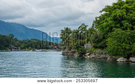 Lake Toba Is A Large Natural Lake Occupying The Caldera Of A Supervolcano, Located In The Middle Of 