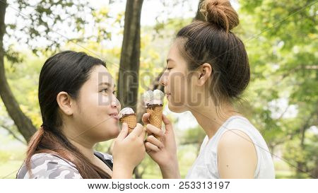 Two People Fat And Cute Girl Eat Ice Cream With Feeling Delicious