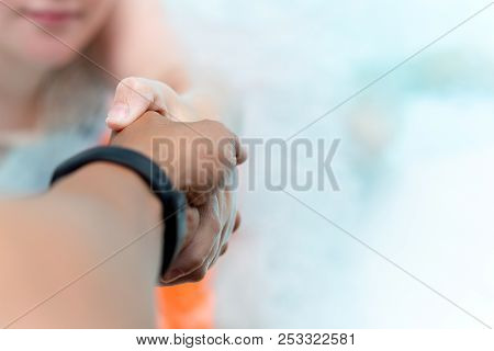 Man Hand Reach Helpnig Achild In A Local Pool On Vacation.