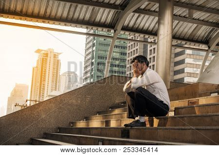 Concept Of Business Failure And Unemployment Problem.exhausted Middle-aged Man Sitting On The Stairs