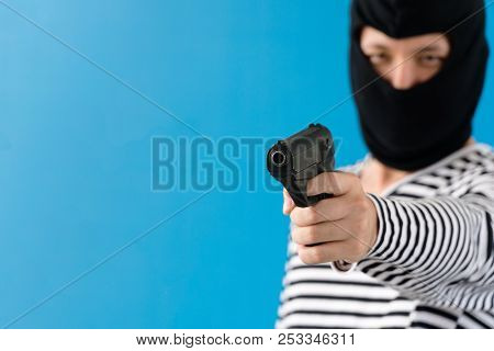 Close Up Gunman Carrying Gun Wearing Black Mask, And Aim At The Goal.robber/man With Masked And Weap