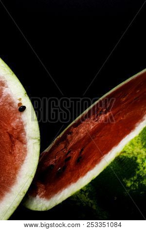One Watermelon Cut In Halves Isolated On Black Background With Clipping Path
