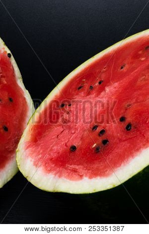 One Watermelon Cut In Halves Isolated On Black Background With Clipping Path