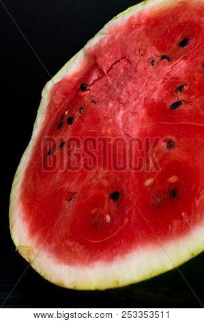 A Half Of Fresh Watermelon Isolated On Black Background.