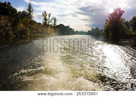 Wave From The Ship On The River In The Autumn Time. Autumn Forest Water Reflection View In The River