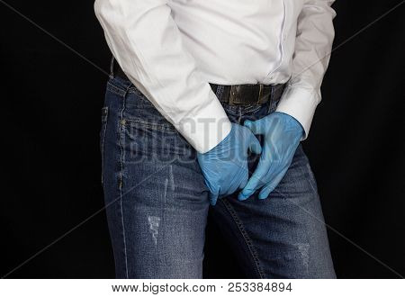 A Man In Medical Gloves Holds On To The Groin, Pain In The Perineum, Prostatitis
