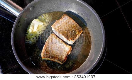 Pan-fried Fish, Two Pieces Of Loban Fillet On The Steaming Frying Pan.