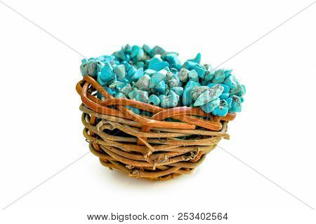 Pile Stones Of Raw Turquoise In Small Wooden Nest On A White Background. Blue And Green Color Stones