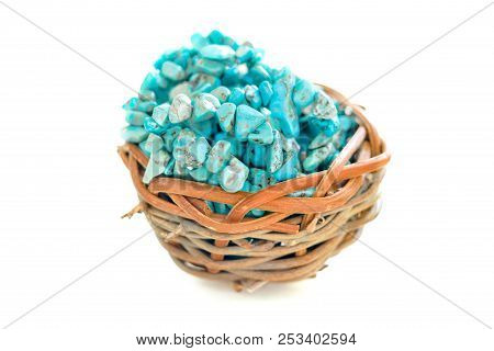 Pile Stones Of Raw Turquoise In Small Wooden Nest On A White Background. Blue And Green Color Stones