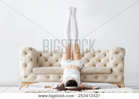 Young Girl Woman Female Teenger Wearing Pajamas Sleepwear, White Top And Stockings Lying On The Floo