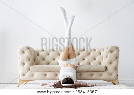 Young Girl Woman Female Teenger Wearing Pajamas Sleepwear, White Top And Stockings Lying On The Floo
