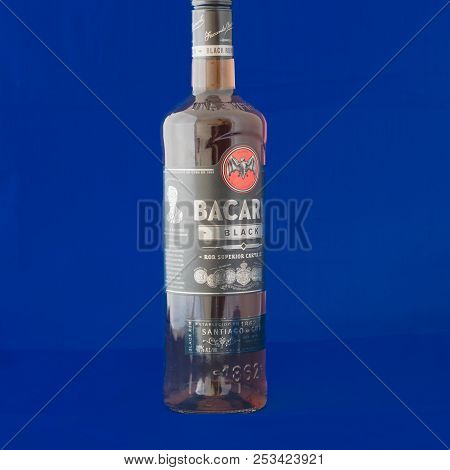 Studio Shot A Bottle Of Bacardi Black Rum Isolated On Blue Background