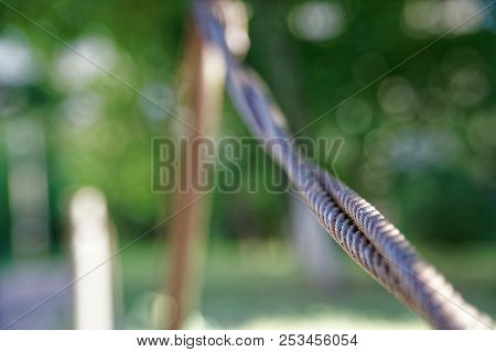 Thick Steel Rope Close Up. Bridge Fence Element. Detailed View. The Surface Of The Steel Cable Is Co
