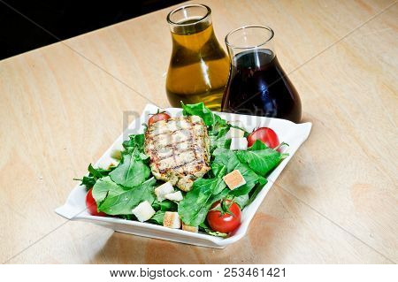 Roasted Black Pepper Lamb Steak With Salads And Fries On A Blue Round Plate. Wooden Texture Backgrou