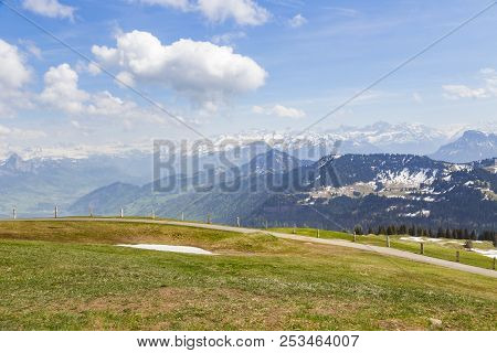 Green Grass Field On Top Of Rigi Kulm Luzern Switzerland With Alps Snow Mountain View A