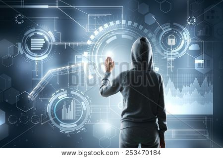 Hooded Female Hacker Using Digital Business Interface On Blurry Background. Thief And Criminal Conce
