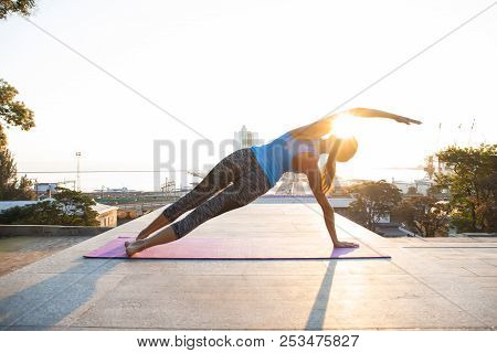 Fitness Woman Doing Planking Yoga Exercises Outdoors At The Beac