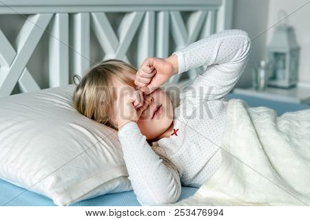 Cute Little Blond Caucasian Girl Awakening At Bed In Morning. Child Wake Up Early To Go To School. S