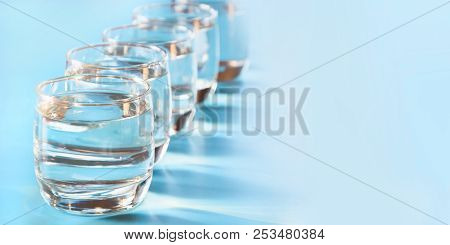 Glasses Of Water On Blue. Close Up. Copy Space. Water Balance For Healthy.