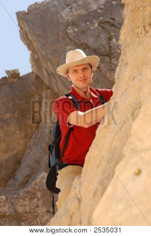 Adult Man Climbing On Rock