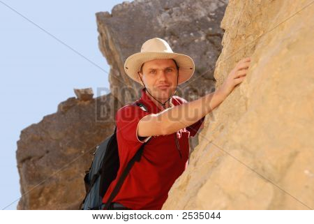 Adult Man Climbing On Rock