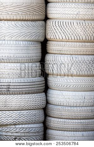 White Tires. Stack Of Car Tyres Painted White. Automobile Background Image. Petrol-head Or Car Vehic