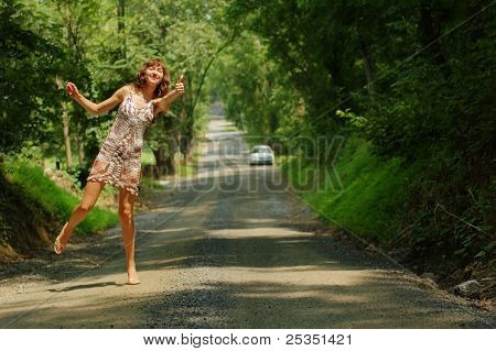 Pretty girl hitching hiking.