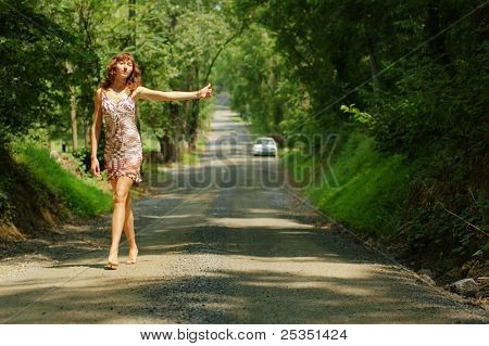 Pretty girl hitching hiking.