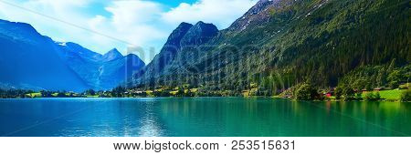 Norway Nordfjord Fjord Panoramic Banner With Glacier, Forest Mountains Landscape And Rural Houses. N