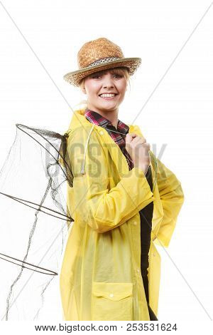 Spinning, Angling, Cheerful Fisherwoman Concept. Happy Woman In Yellow Raincoat Holding Empty Fishin