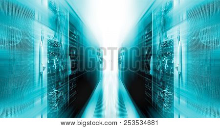 Shot Of Corridor In Working Data Center Full Of Rack Servers And Supercomputers With High Speed Iner