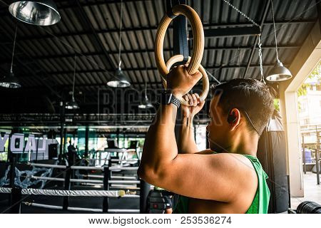 Asian Man Athlete Gymnast Rings Exercise In Gymnastics Exercise Chest 
Workout On Bench Press Cable 