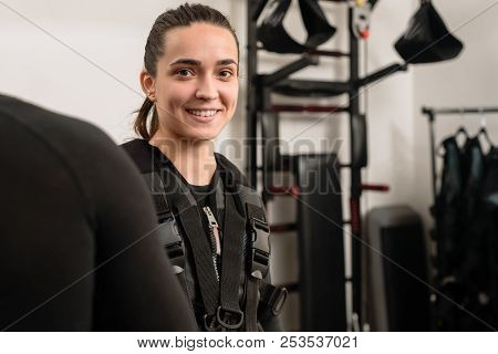 Happy Young Woman Wearing Electro Muscular Stimulation Vest