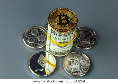 Coins Of Different Crypto-currencies With Dollars. Bitcoin, Dash, Ripple, Ethereum Litecoin