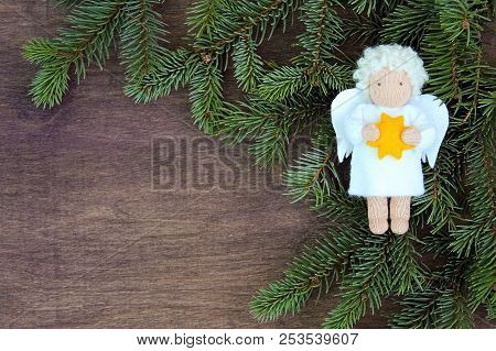White Felt Christmas Angel With Yellow Star In Hands To Fresh Natural Branches Of Christmas Tree Spr