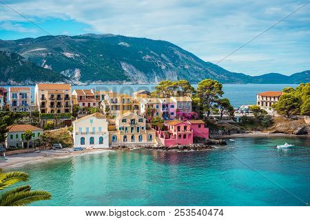 Assos Village. Beautiful View To Vivid Colorful Houses Near Blue Turquoise Colored Transparent Bay L