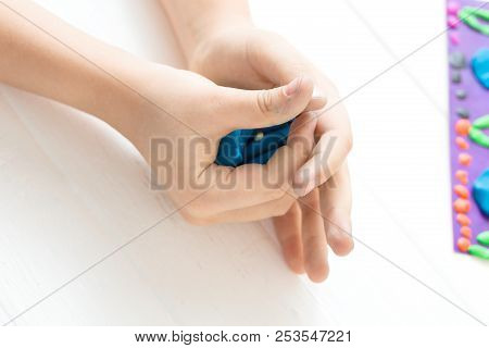 A Child Kneads Plasticine And Sculpts An Aquarium With Fish. Tutoring With Children