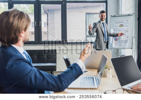 Professional Businessmen Discussing New Project During Presentation
