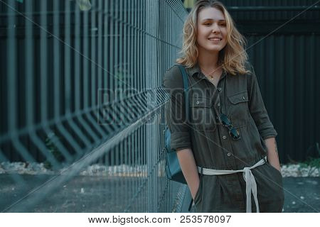 Urban People Concept. Carefree Young Woman Portrait Smiling, Drssed In Chaki Romper. City Lifestyle 