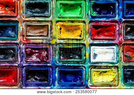 Closeup Background Texture Of Messy, Used Watercolor Paintbox. Creative Background. Paintings Art Co