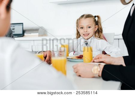 Partial View Of Family Having Breakfast Together At Home