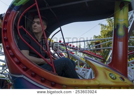 The Guy Sits On The Carousels In Gagarin Park, July 1, 2018, Russia, The City Of Sterlitamak
