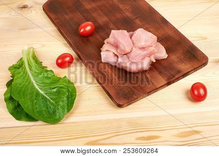 Raw Turkey Fillet Pieces On A Cutting Board Wooden Background