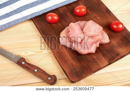 Raw Turkey Fillet Pieces On A Cutting Board Wooden Background