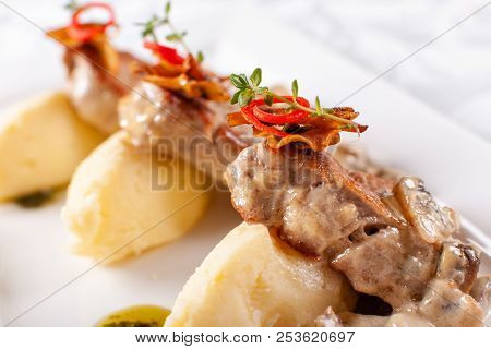 Pork Medallions With Mashed Potato And Mushrooms. Pork Tenderloin On A White Plate, Good Serving. Re