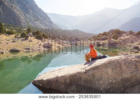 Wanderlust time. Man hiking in beautiful Fann mountains in Pamir, Tajikistan. Central Asia.