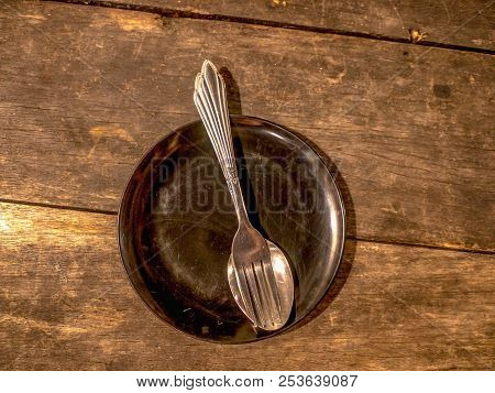 Cultery On The Ptate On Wooden Background